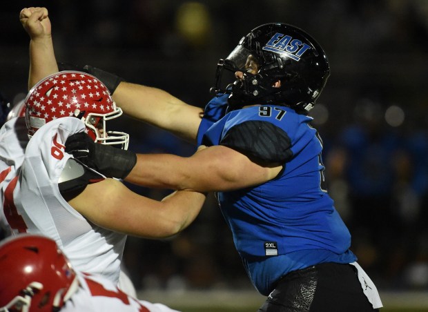 Naperville Central's Teddy Vilim (64) tries to block Lincoln-Way East's Gage LaDere (97) during a Southwest Valley Conference game Friday, Oct. 25, 2024 in Frankfort, IL. (Steve Johnston/for the Daily Southtown)