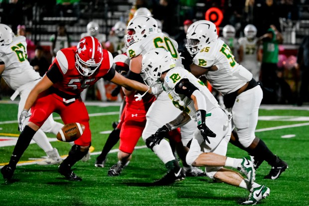 Marist's Joshua Loera (55) recovers a fumble by Providence's Gavin Hagan (32) during a game at Marist High School in Chicago, Ill. on Friday, Oct. 4, 2024. (Vincent Alban / Daily Southtown)