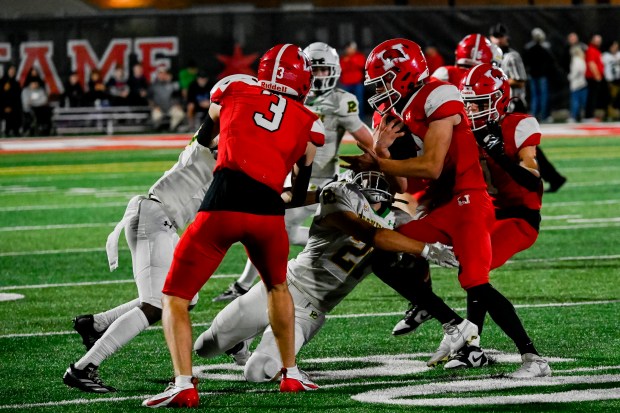 Marist's Jake Ritter (12) runs the ball during a game against Providence at Marist High School in Chicago, Ill. on Friday, Oct. 4, 2024. (Vincent Alban / Daily Southtown)