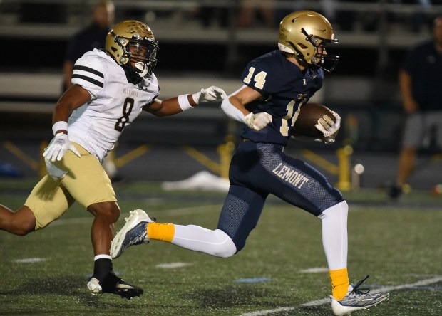 Lemont's Matthew Ciesla (14) tries to out run Richards' Khalil LaValle (8) after his catch during a South Suburban Conference game Friday, Oct. 11, 2024 in Lemont, IL. (Steve Johnston/for the Daily Southtown)