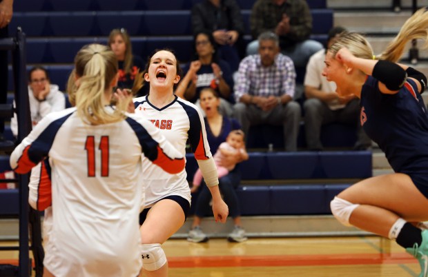 Stagg's Maggie Ziel, left, Karolina Stonkus, center, and Abbi Lujano, right, celebrate their win against Chicago Christian during the volleyball game in Palos Hills on Friday, Oct. 9, 2024. (James C. Svehla / for the Daily Southtown)