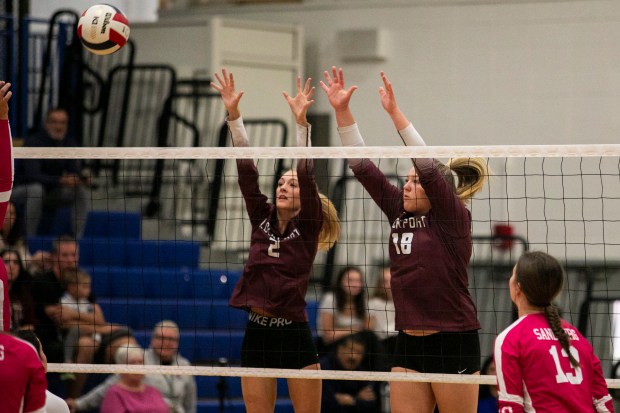 Lockport's Emily McGraw (2) and Jenna Kolosta (18) attempt to block a Sandburg hit during a Southwest Suburban Conference game in Orland Park on Thursday, Oct. 3, 2024. (Vincent D. Johnson / Daily Southtown)