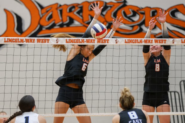 Lincoln-Way West's Lily Goyer (6) defends a spike against Lincoln-Way East during an SWSC match in New Lenox on Thursday, Oct. 10, 2024. (Troy Stolt / for the Daily Southtown)