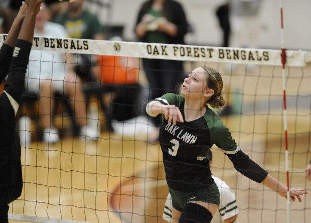 Oak Lawn's Amina Maali (3) follows though on her kill attempt against Oak Forest during a South Suburban Conference volleyball match Tuesday, Oct. 8, 2024 in Oak Forest, IL. (Steve Johnston / Daily Southtown)