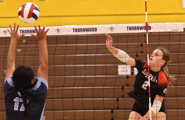 Shepard's Jenna Powers (2) slams a shot over the head or Reavis's Quetzalli Pichardo Aich )17) during the Class 4A Thornwood Regional volleyball semifinals on Tuesday, Oct. 29, 2024. (John Smierciak / Daily Southtown)