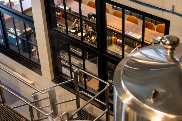 A large bay of windows makes the brewery's operations visible from the bar and restaurant area of the Homewood Brewing Company. (Vincent D. Johnson / for the Daily Southtown)