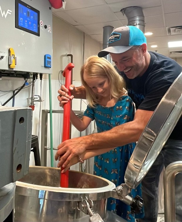 Maggie DeVries works with Arrowhead Ales owner Mike Bacon to craft a beer called Keepin' it Teal, inspired by her favorite color. Following Maggie's death, Bacon and her family have continued the fundraiser, donating a portion of the beer's profits to an organization selected by Maggie's mother. (Erin DeVries)