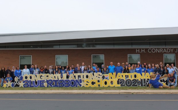 School District 117 staff gather outside Conrady Junior High School in Hickory Hills to celebrate it being named a 2024 National Blue Ribbon School. (Sean Joyce/District 117)