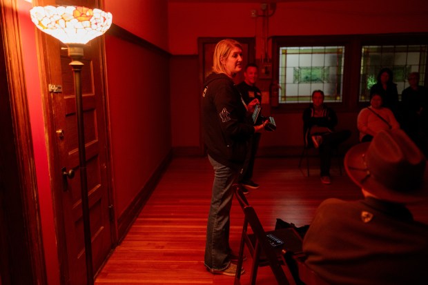 Lesley Tuton, of Other Side Investigations, speaks to a guests participating in a paranormal investigation hosted by Other Side Investigations Oct. 25, 2024. (Vincent Alban/for the Chicago Tribune)