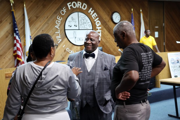 Interim Ford Heights Mayor Freddie Wilson, center, talks to well-wishers after presiding over a Village Board meeting on Oct. 2, 2024. (Terrence Antonio James/Chicago Tribune)