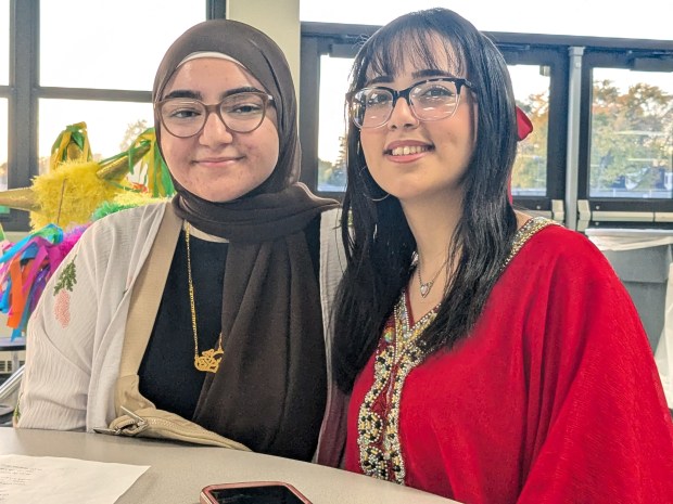 Students Sarah Alqazaq and Rory Ali, both juniors at Oak Lawn Community High School, prepare to perform in the annual Community Outreach event at the school in Oak Lawn. (Janice Neumann/Daily Southtown)