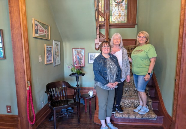 Ann Allspaugh, from left, Carol Lagadinos and Cindy McMahon gather at the Pullman House Project Welcome Center. The three have been connected by the Historic Pullman House Tour as Allspaugh and Lagadinos bought homes after one of the tours while McMahon is a longtime tour guide for the annual tours. (Janice Neumann/Daily Southtown)