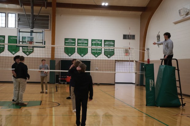 Providence Catholic Senior Brendan Grohn, right, officiates a volleyball game during a class at the school in New Lenox that teaches students how to be referees and umpires. A member of the school's football team, he said he took the class because "a different view it might make me even better as an athlete.