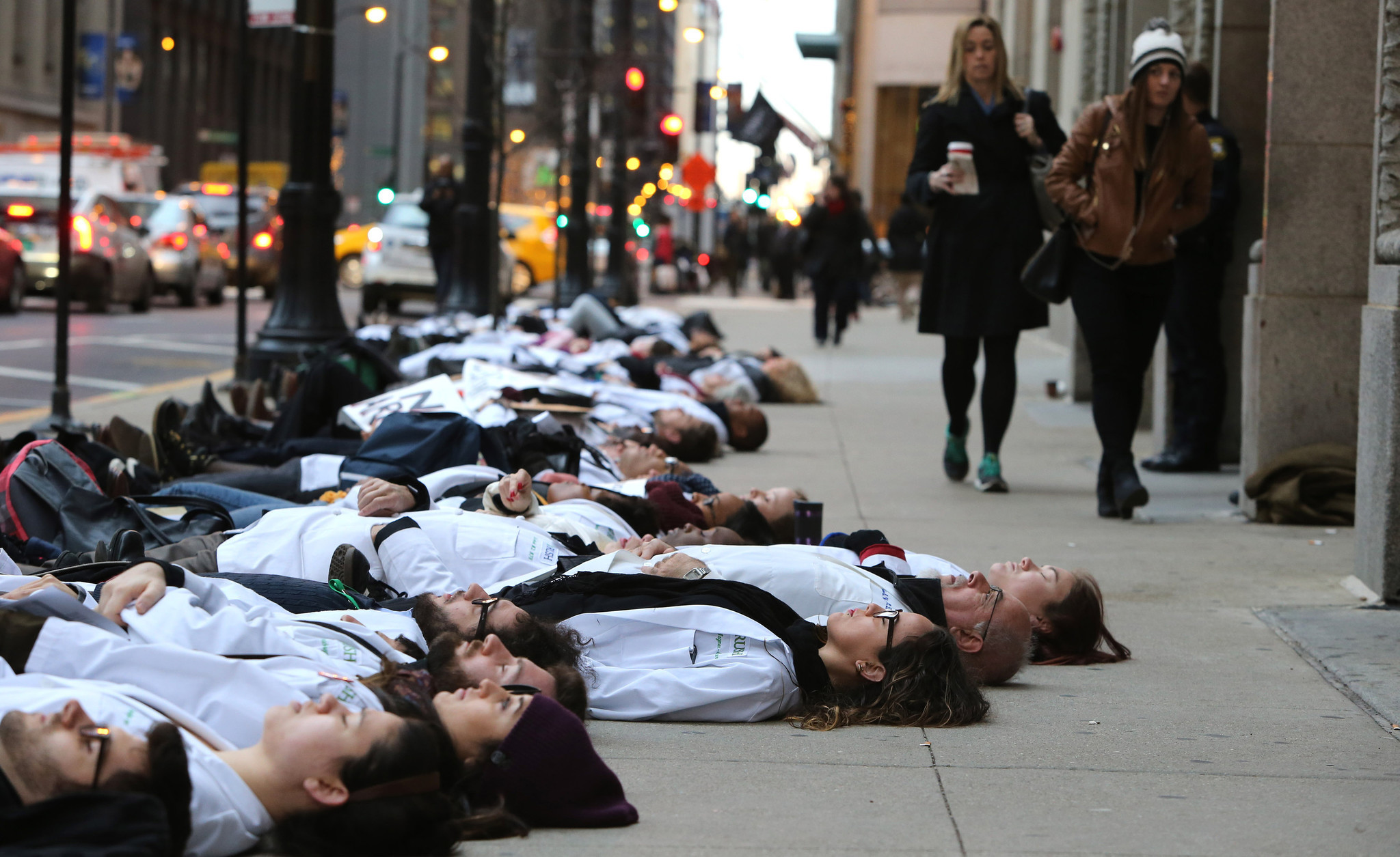 Protesters stage a die-in outside City Hall in the Loop...