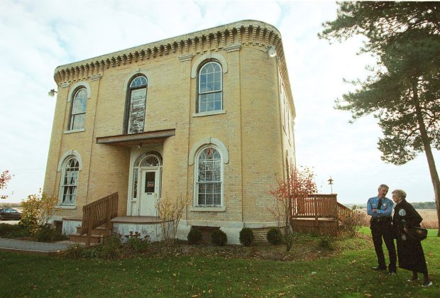 Verna Hogan, chairman of fundraising and a Bull Valley resident, is with Bull Valley Police Chief Norbert Sauers as they survey the work to be done on Stickney House, which also serves as the Bull Valley Village Hall, Oct. 19, 1999. The Stickney House/Bull Valley Village Hall was built in 1856 and is famously haunted. (Jerry Tomaselli/Chicago Tribune)