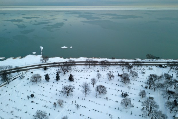 Graves can be seen amongst the snow at Calvary Catholic Cemetery along the shore of Lake Michigan on Feb. 17, 2021, in Evanston. (Erin Hooley/Chicago Tribune)