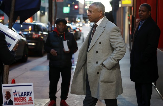 Cook County Board of Review Commissioner Larry Rogers Jr., center, arrives for a campaign fundraising event in the 100 block of West Hubbard Street in Chicago on Feb. 15, 2024. (John J. Kim/Chicago Tribune)