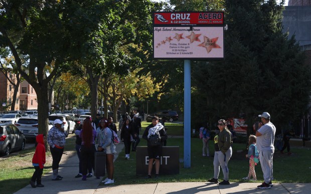 Students and parents gather after the final bell outside Cruz K-12, an Acero charter school, Oct. 10, 2024, in Chicago. The public charter school network announced plans to close seven of its 15 schools starting next year, including Cruz K-12. (John J. Kim/Chicago Tribune)