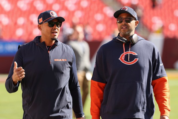 Chicago Bears general manager Ryan Poles and assistant general manager Ian Cunningham walk the field before the game against the Washington Commanders. (Brian Cassella/Chicago Tribune)