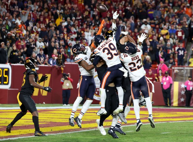 The Chicago Bears tip a Hail Mary pass that Washington Commanders wide receiver Noah Brown (85) caught for a touchdown to win the game on the final play of the fourth quarter Sunday, Oct. 27, 2024, at Northwest Stadium in Landover, Maryland. (Brian Cassella/Chicago Tribune)