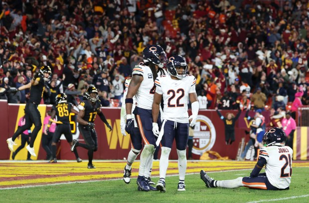 Chicago Bears defenders Tremaine Edmunds (49), Elijah Hicks (22) and Jaylon Jones (21) get up while Washington Commanders wide receiver Noah Brown (85) celebrates his Hail Mary touchdown catch to win the game Sunday, Oct. 27, 2024, at Northwest Stadium in Landover, Maryland. (Brian Cassella/Chicago Tribune)