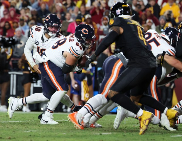 Chicago Bears center Doug Kramer Jr. (68) fumbles the ball in a handoff from Caleb Williams at the goal line in the fourth quarter Sunday, Oct. 27, 2024, at Northwest Stadium in Landover, Maryland. (Brian Cassella/Chicago Tribune)