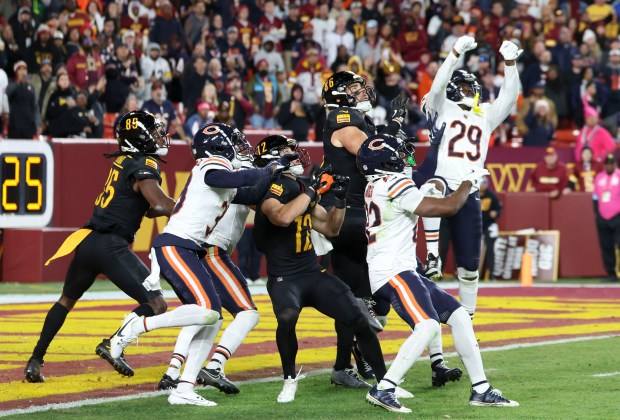 Commanders tight end Zach Ertz (86) and Bears cornerback Tyrique Stevenson (29) go up for the Hail Mary pass that Commanders wide receiver Noah Brown (85) caught for a touchdown on the final play Sunday, Oct. 27, 2024, at Northwest Stadium in Landover, Md. (Brian Cassella/Chicago Tribune)