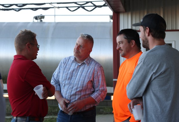 U.S. Rep. Eric Sorensen, second from left, talks with farmers after a tour of Mitchell Dairy and Grain Oct. 8, 2024, in Winnebago. (John J. Kim/Chicago Tribune)