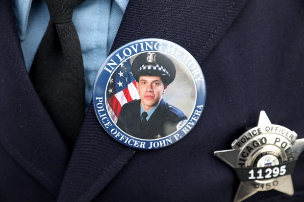 A Chicago police officer wears a button for slain Officer John Rivera at the wake at Elmwood Funeral Chapel, March 28, 2019. (Chris Sweda/Chicago Tribune)