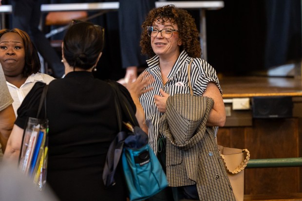 Candidate for Chicago Board of Education Maggie Cullerton Hooper, 2nd district, center, talks to Candidate for Chicago Board of Education Carmen Gioiosa, 4th district, following a School Board Candidate Forum before the upcoming election featuring candidates from districts 2 and 4 at Lane Tech College Prep High School in Chicago on Oct. 5, 2024. The forum happened following yesterday's news that the entire school board is resigning. (Tess Crowley/Chicago Tribune)