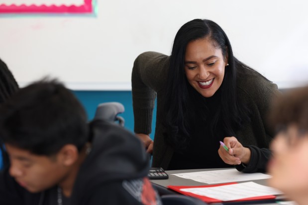 Brenda Cora, of the Noble Schoolsl charter network, talks with a student in an algebra class at Muchin College Prep on Tuesday, Oct. 1, 2024, in Chicago. Cora was named the new CEO of Noble Schools. (John J. Kim/Chicago Tribune)