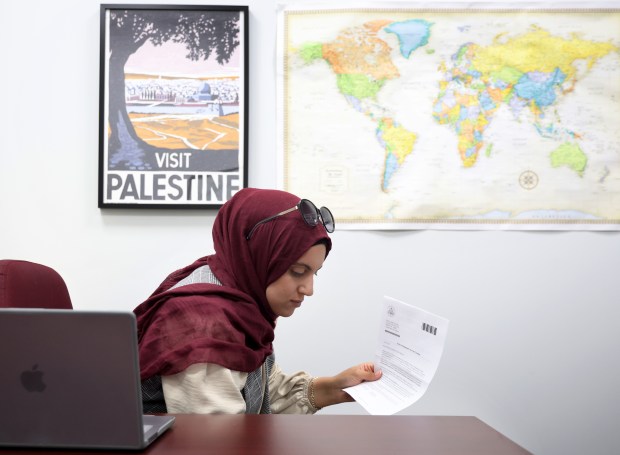 Fidaa Elaydi, an immigration attorney, looks over her case work at her office on Oct. 1, 2024, in Worth. (Stacey Wescott/Chicago Tribune)