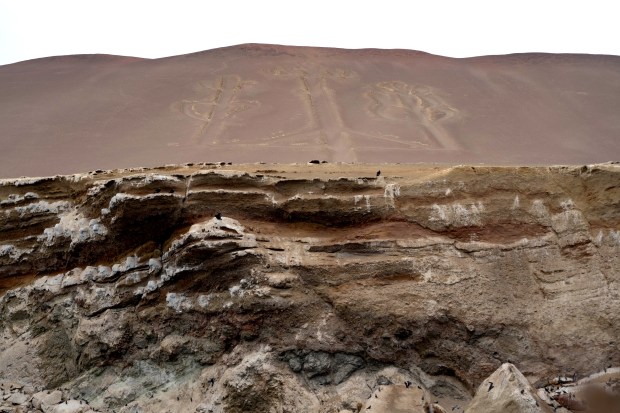 The Paracas Candelabra, a mysterious geoglyph etched into a seaside hill, at Paracas National Reserve in Peru, Aug. 23, 2024. (Angela Ponce/The New York Times)