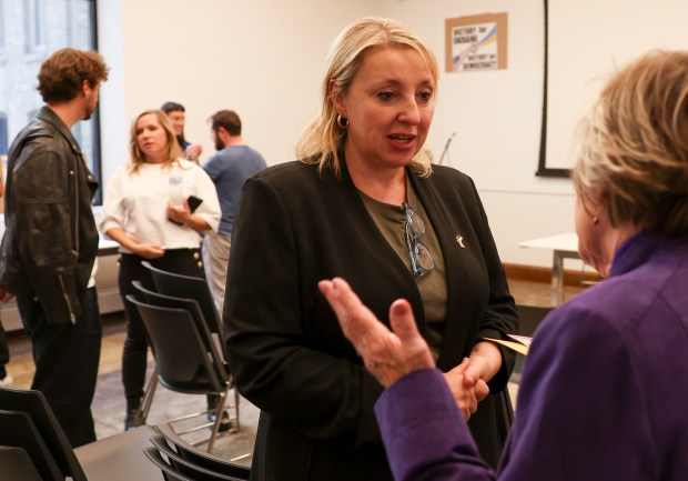 Dr. Mariya Dmytriv-Kapeniak, center, mingles after a non-partisan voter education forum regarding support for Ukraine at Milwaukee Public Library in Milwaukee on Oct. 20, 2024. (Eileen T. Meslar/Chicago Tribune)