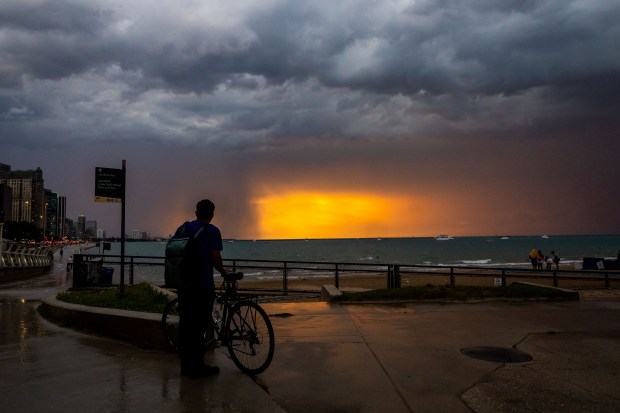 A storm rolls in at Ohio Street Beach after a day of the heat index at triple digits on Aug. 27, 2024. (Tess Crowley/Chicago Tribune)