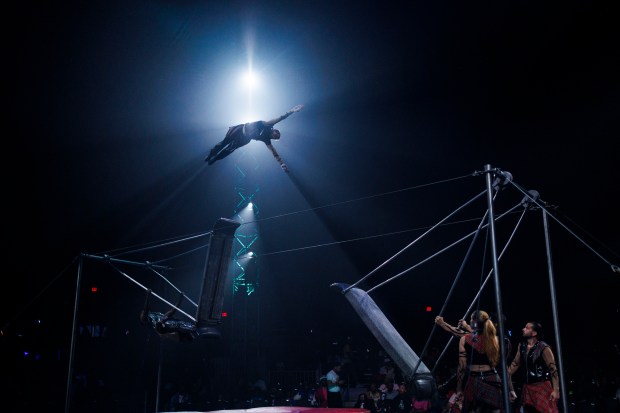 An acrobat flies through the air at UniverSoul Circus on Oct. 2, 2024, in Chicago. (Armando L. Sanchez/Chicago Tribune)