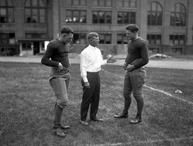 Meeting of the Illini board of strategy: Harold "Red" Grange, from left, Coach Robert Zuppke, and Earl Britton at the University of Illinois in 1924. Grange would play his first game with the Bears only five days after his final game with Zuppke and the Illini. (Chicago Tribune historical photo)