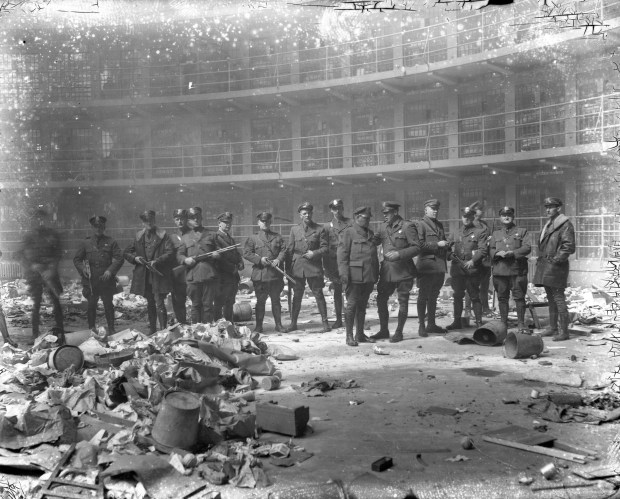 State highway police officers help restore order in the circular cell blocks at Stateville Prison after 1,500 convicts rioted, lighting several buildings on fire, on March 18, 1931. Three convicts were shot during the rioting, one of them was gravely wounded with a bullet to the abdomen. (Chicago Herald and Examiner)