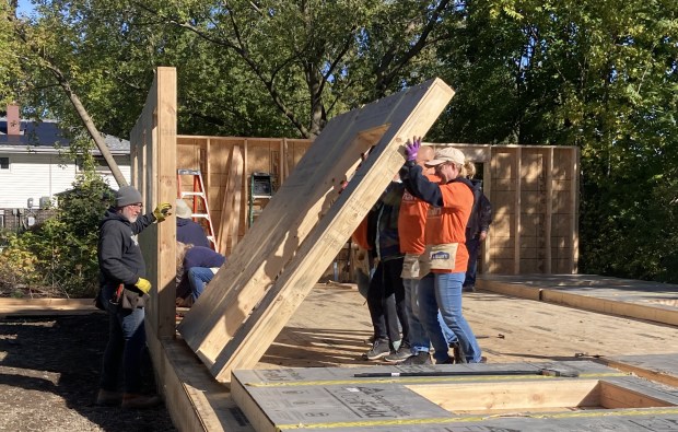 Habitat for Humanity volunteers and workers help erect a wall on a new home in Waukegan.  (Steve Sadin/For the Lake County News-Sun)