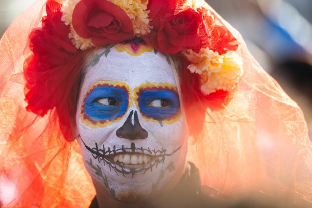 Marivel Luevanos smiles after finishing the Carrera de los Muertos 5K in the Pilsen neighborhood of Chicago on Nov. 2, 2024. (Tess Crowley/Chicago Tribune)