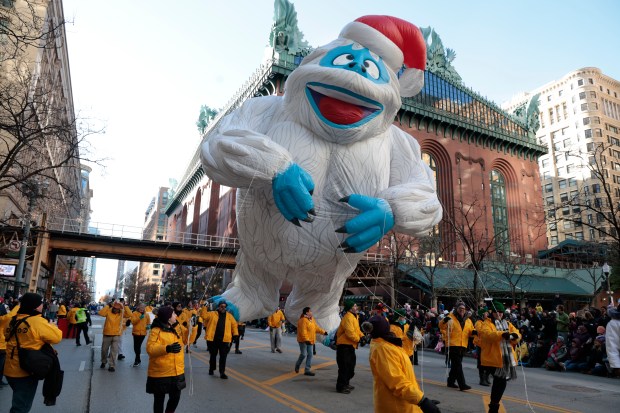 A giant balloon of the Abominable Snow Monster is carried down State Street during the 89th annual Chicago Thanksgiving Parade on Nov. 23, 2023.