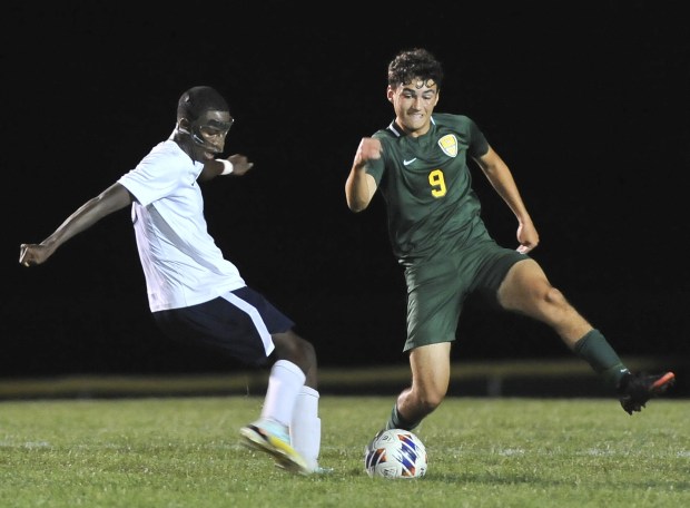 West Aurora's Pacifique Ndayishimiye starts to kick as Waubonsie Valley's Michael Spano (9) defends during a nonconference game in Aurora on Tuesday, Aug. 30, 2022.