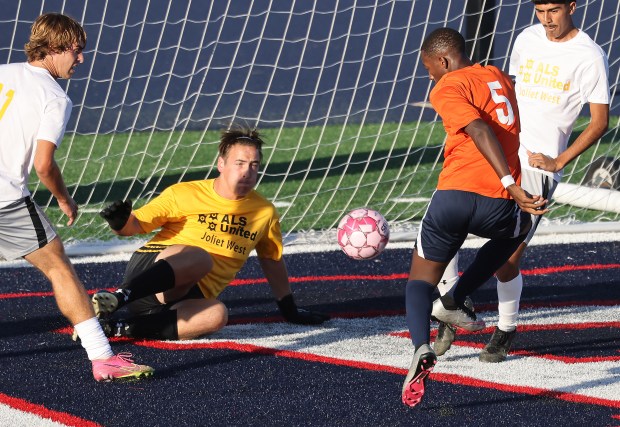 West Aurora's Pacifique Ndayishimiye (5) scores against Joliet West goalkeeper Gavin Ringhofer during a Southwest Prairie West game in Aurora on Thursday, Oct. 5, 2023.