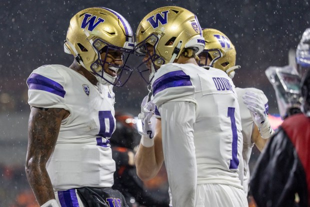 Wide receiver Rome Odunze of the Washington Huskies celebrates his touchdown catch with Michael Penix Jr. of the Washington Huskies during the first half against the Oregon State Beavers at Reser Stadium on Nov. 18, 2023, in Corvallis, Oregon.