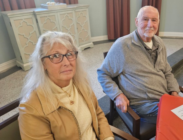 Diane Cordello of Carol Stream and her father John Cella celebrate his being recognized as a veteran Monday during a ceremony at the Bardwell Residences in Aurora. (David Sharos / For The Beacon-News)