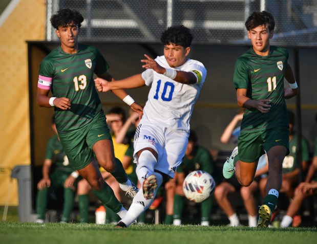 Marmion's Giovanni Magana (10) takes a shot at the goal as Waubonsie Valley's Amiel Nichani (13) and Evan Wojtowich (11) defend during a game on Thursday, Aug. 29, 2024 in Aurora...(Jon Cunningham/for The Beacon-News)