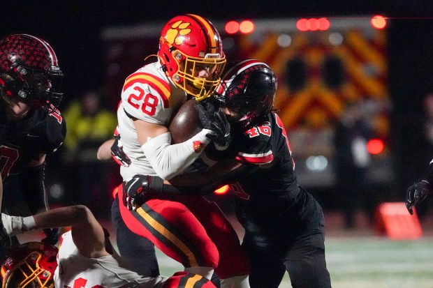 Lincoln-Way Central's Jalen Byrd (46) hits Batavia's Nathan Whitwell (28) during a Class 7A state semifinal football game at Lincoln-Way Central High School on Saturday, Nov 23, 2024. (Sean King / for The Beacon-News)