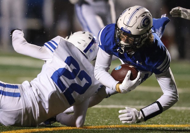 Geneva's Finnegan Weppner (8)secures a Anthony Chahino pass in the third quarter for a first down as Burlington Central's Parker Auxier (22) defends during a Class 6A second-round game Saturday, Oct. 9, 2024 in Geneva. (H. Rick Bamman / The Beacon-News)