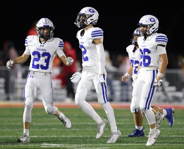 Geneva's Luke Frieders (23) and Dane Turner (2) celebrate Tate Beran's (26) fourth quarter interception against Batavia during a DuKane Conference game in Batavia on Friday, Oct. 4, 2024.(H. Rick Bamman / The Beacon-News)