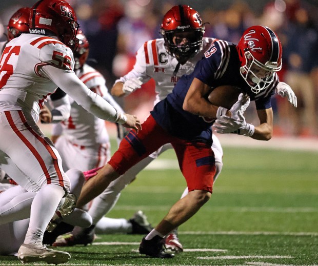 West Aurora's Reece Powers (13) spins through a tackle against Huntley during a Class 8A first-round game in Aurora on Friday, Nov. 1, 2024.(H. Rick Bamman / The Beacon-News)